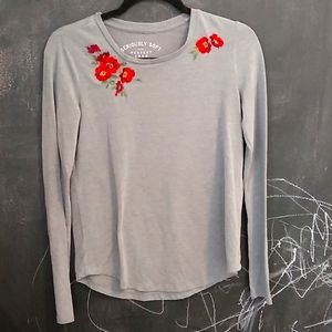 Grey long sleeve top wish flowers at too